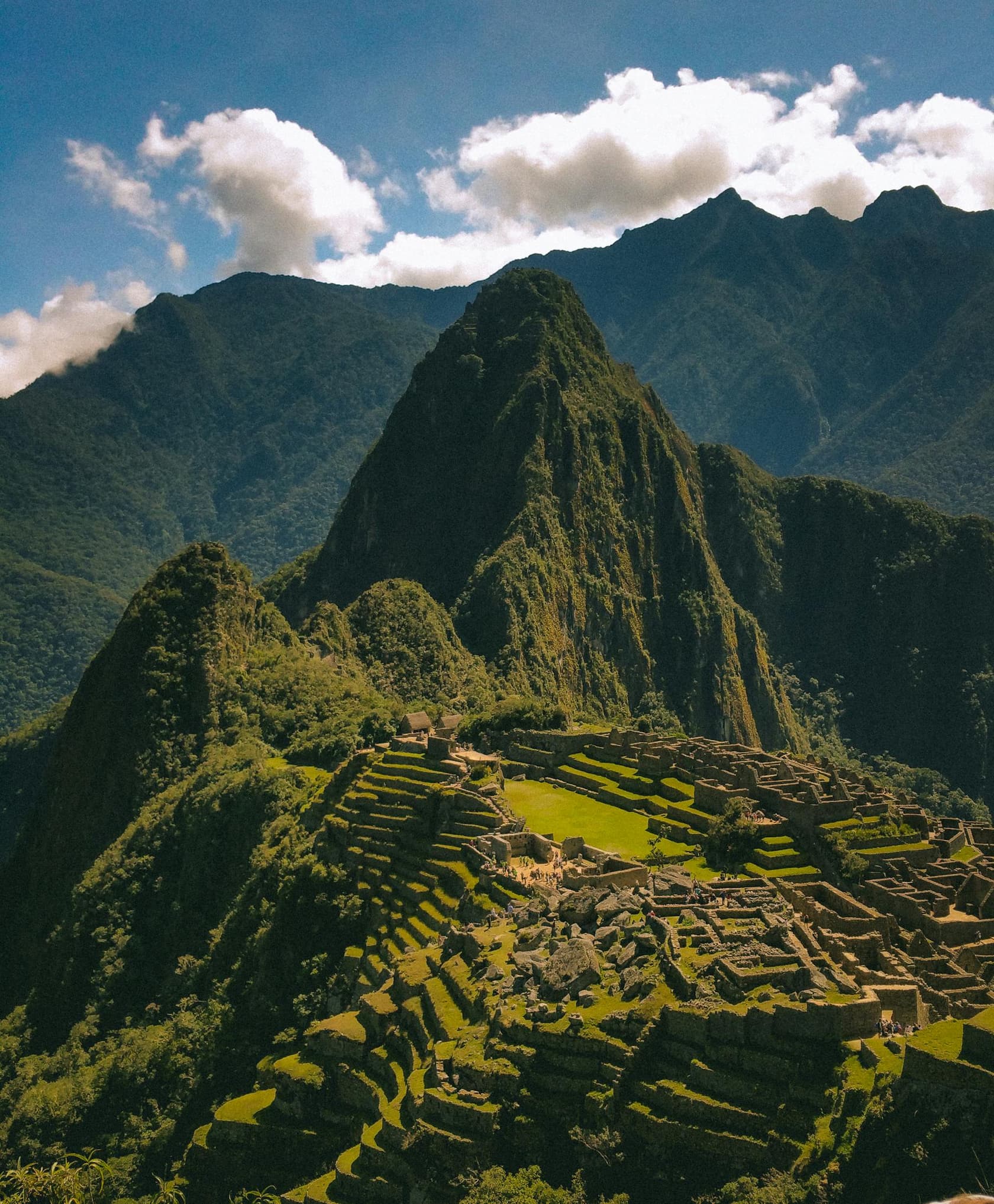 Machu Picchu in Peru with mountain peaks behind the ruins